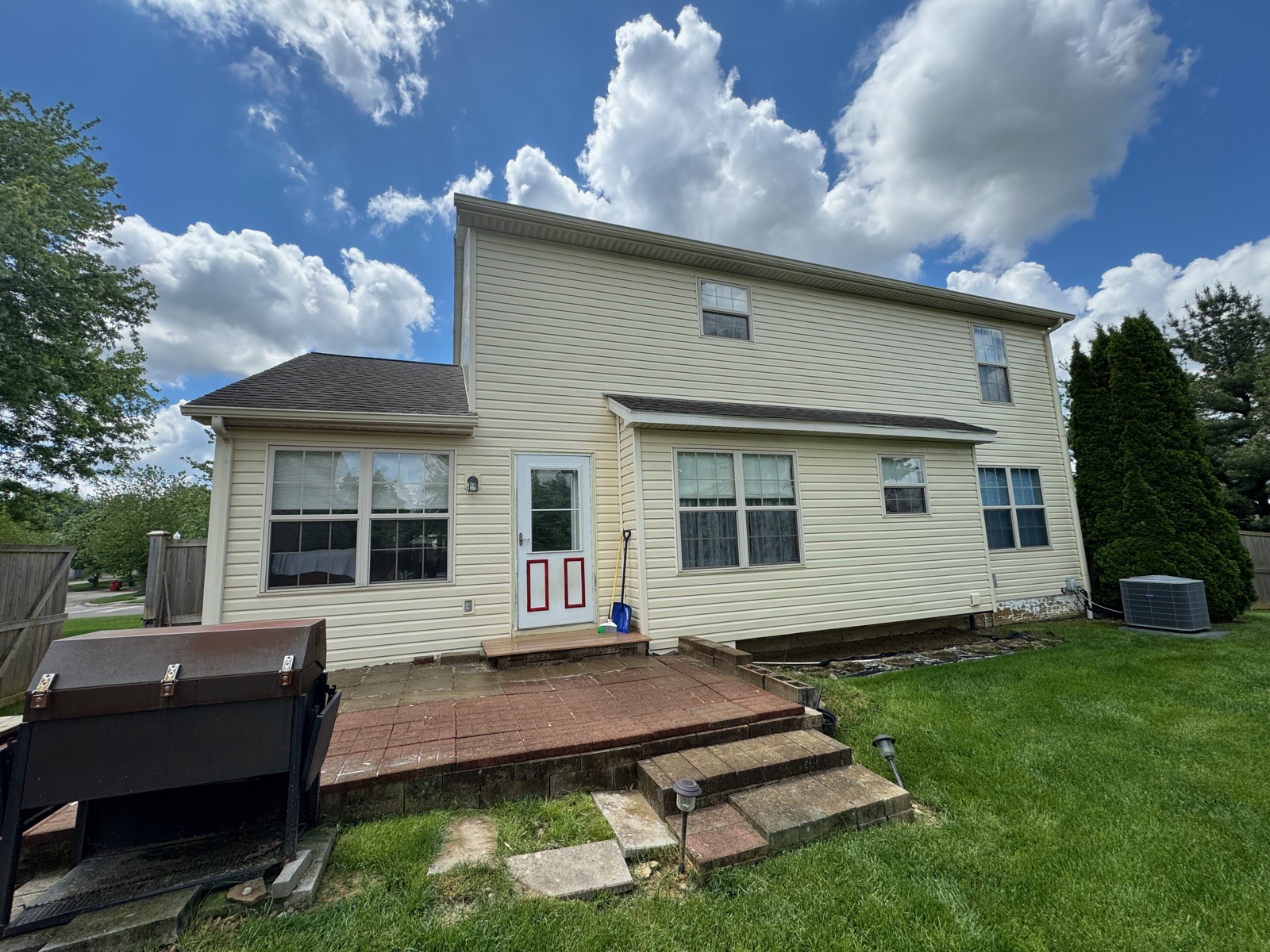 The same home with bright, clean siding after soft washing