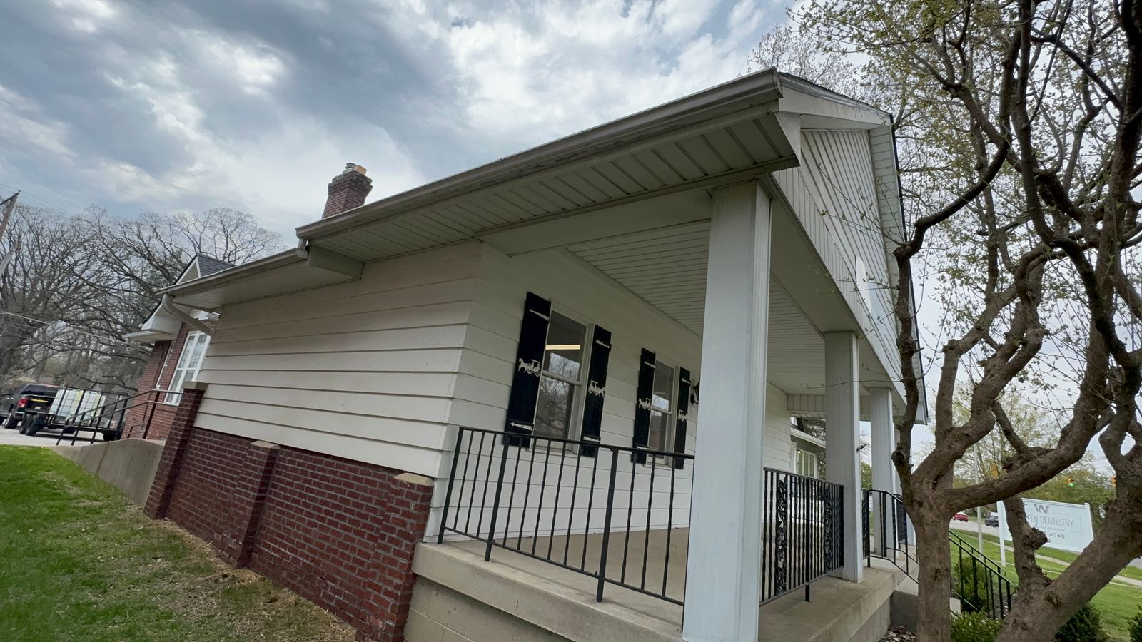White gutters and fascia brightened over a brick home